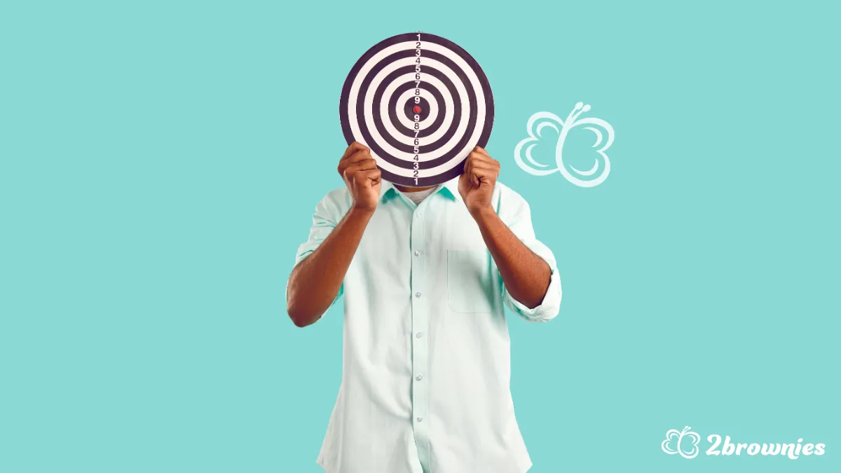 Person covering face with a target board